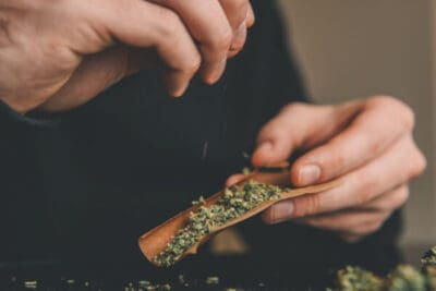 Rolling a blunt with the cannabis strain from the cannabis store near me